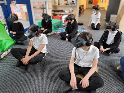 Children sitting on floor with using Virtual Reality technology