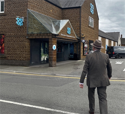 Rear view of Commissioner approaching Uppingham Co-op
