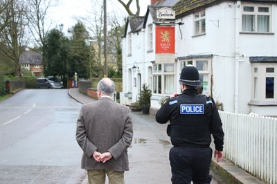 Rear view of PCC and PC Jake Spruce walking down street in Whissendine