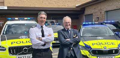 Rupert Matthews with Chief Constable Rob Nixon in front of police vehicles
