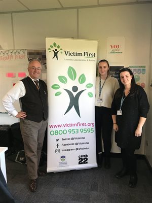 Commissioner with Victim First banner and 2 representatives